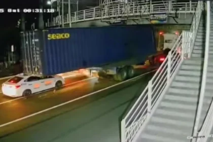 Taxi crushed after container falls from trailer truck in Manila